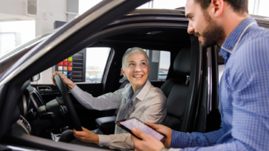 An automotive customer chats with her salesperson about the vehicle’s features