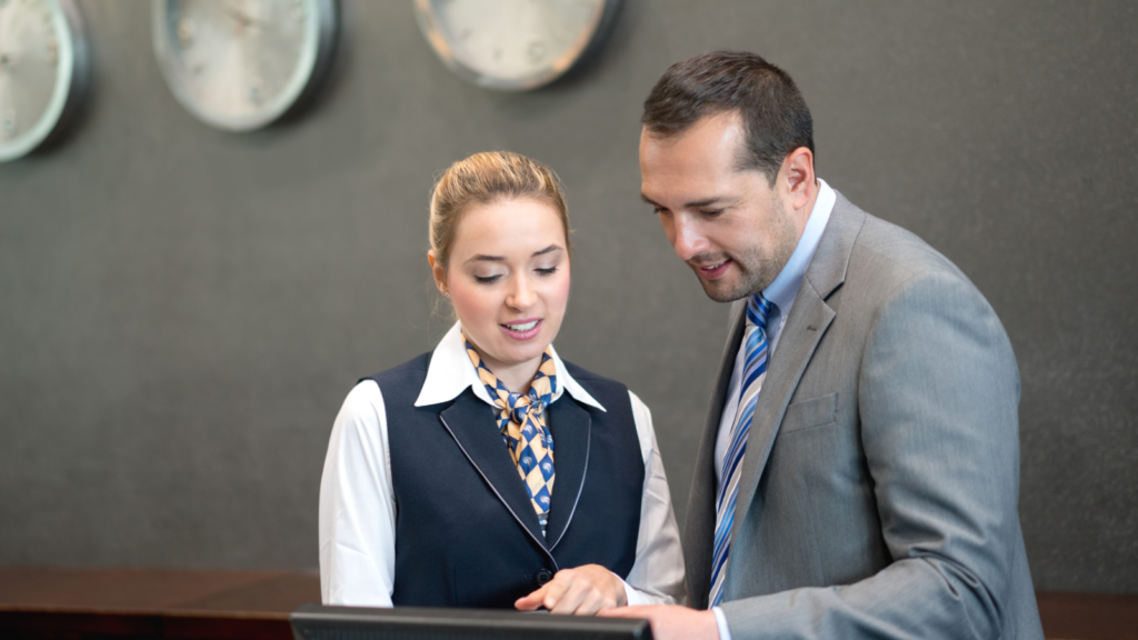 A front desk employee collaborates with the hotel manager