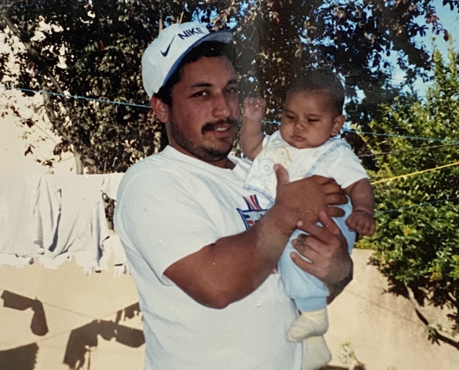 Jose Ayala as a baby in his dad's arms